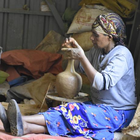 A member of the cooperative making coffee pot