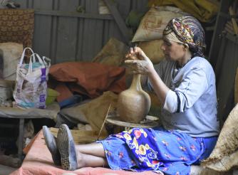 A member of the cooperative making coffee pot